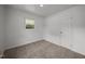 Bright bedroom featuring neutral carpet, a framed window, and fresh white walls at 1713 Elder Ct, Burlington, NC 27215