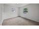 Neutral bedroom offers carpet, two windows, and a closet at 1713 Elder Ct, Burlington, NC 27215