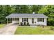 Charming single-story home with white brick exterior, dark shutters, and well-manicured front yard at 1713 Elder Ct, Burlington, NC 27215