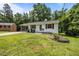 Beautiful white brick home with a covered side porch and landscaped front yard at 1713 Elder Ct, Burlington, NC 27215