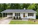 Charming single-story home with white brick, black shutters, and a well-manicured lawn at 1713 Elder Ct, Burlington, NC 27215
