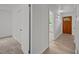 Bright hallway featuring closet, new flooring, and natural light from the front door at 1713 Elder Ct, Burlington, NC 27215