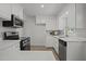 Bright kitchen with modern stainless steel appliances, white cabinets, and quartz countertops at 1713 Elder Ct, Burlington, NC 27215