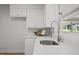 Close up of the kitchen sink with sleek faucet and stainless steel sink overlooking the yard at 1713 Elder Ct, Burlington, NC 27215