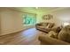 Comfortable living room featuring a large window with lush greenery and plush seating at 1713 Elder Ct, Burlington, NC 27215