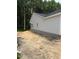 Neutral siding and trim show the exterior side of a new construction home with daylight basement at 185 Rollins Acres Ln, Lillington, NC 27546