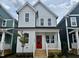 Charming two-story home featuring a bright red front door and a quaint covered porch at 1907 Plott Balsam Dr, Wendell, NC 27591