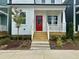Close-up view of the entry to a delightful home showing the striking red front door and concrete steps at 1907 Plott Balsam Dr, Wendell, NC 27591
