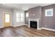 Open living space with sleek fireplace, wood floors, and light-filled windows at 1907 Plott Balsam Dr, Wendell, NC 27591