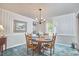 Traditional dining room featuring wood table, chandelier, and wallpaper at 1913 Fawndale Dr, Raleigh, NC 27612