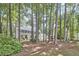 Traditional two-story home surrounded by mature trees, offering curb appeal and a sense of privacy at 1913 Fawndale Dr, Raleigh, NC 27612