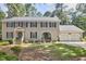 Traditional two-story home with blue shutters, double front doors, and a two-car attached garage at 1913 Fawndale Dr, Raleigh, NC 27612