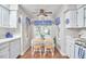 Bright kitchen with white cabinets, brick floor, and blue accents at 1913 Fawndale Dr, Raleigh, NC 27612