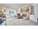 Spacious living room with brick fireplace, piano, and french doors at 1913 Fawndale Dr, Raleigh, NC 27612