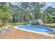 Beautiful pool area with ample deck space and mature landscaping, perfect for outdoor entertainment and relaxation at 1913 Fawndale Dr, Raleigh, NC 27612