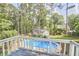 Beautiful in-ground pool in a private backyard with mature trees, viewed from deck at 1913 Fawndale Dr, Raleigh, NC 27612