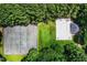 Overhead shot of a tennis court and community pool surrounded by a lush green forest at 213 Bracken Ct, Raleigh, NC 27615
