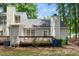 Backyard view featuring a wooden deck, lush trees, and outdoor space perfect for relaxation and entertainment at 213 Bracken Ct, Raleigh, NC 27615