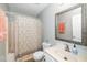 Clean bathroom featuring a single vanity and a shower/tub with a patterned curtain, with a mirror at 213 Bracken Ct, Raleigh, NC 27615