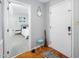 Inviting entryway with hardwood floors, a neutral color scheme, and a glimpse into a cozy bedroom at 213 Bracken Ct, Raleigh, NC 27615