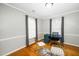 Bright home office with hardwood floors, featuring a modern desk, stylish chairs, and plenty of natural light at 213 Bracken Ct, Raleigh, NC 27615