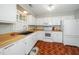 Functional kitchen featuring white cabinets, appliances, and a sink with a window view, creating a bright cooking space at 213 Bracken Ct, Raleigh, NC 27615