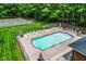 Aerial view of a community pool surrounded by lounge chairs and a tennis court in the background at 213 Bracken Ct, Raleigh, NC 27615
