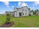 Beautifully landscaped backyard showcasing the home's covered patio and well-manicured lawn at 215 Faith Avenue, Sanford, NC 27330