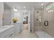 Bright bathroom featuring double vanities, quartz countertops, modern fixtures, and a shower at 215 Faith Avenue, Sanford, NC 27330