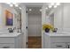 Bright bathroom featuring double vanities, quartz countertops, modern fixtures, and neutral tile at 215 Faith Avenue, Sanford, NC 27330
