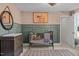 Charming Bedroom with sage wainscoting, complemented by a crib and coordinating decor at 215 Faith Avenue, Sanford, NC 27330