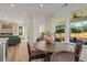 Cozy breakfast nook with lots of windows, hardwood floors, and views into the open living room with a fireplace at 215 Faith Avenue, Sanford, NC 27330