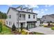 Inviting two-story home boasting a covered porch, black accents, and meticulously maintained landscaping at 215 Faith Avenue, Sanford, NC 27330