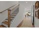 Inviting foyer with hardwood floors and staircase, leading to an open living area at 215 Faith Avenue, Sanford, NC 27330