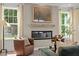 Inviting living room with modern fireplace, neutral decor, large windows, and lots of natural light at 215 Faith Avenue, Sanford, NC 27330