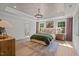A spacious main bedroom with a decorative tray ceiling and a large patterned rug at 215 Faith Avenue, Sanford, NC 27330