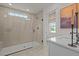 Modern bathroom featuring a glass-enclosed shower with tiled walls and quartz countertops at 215 Faith Avenue, Sanford, NC 27330