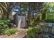 Landscaped backyard featuring a storage shed and mature trees at 2302 Fordcrest Dr, Apex, NC 27502