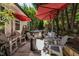 Backyard patio featuring comfortable seating under red umbrellas with a glimpse of a relaxing hot tub at 2302 Fordcrest Dr, Apex, NC 27502