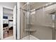 Contemporary glass enclosed shower with a tiled surround, built-in shelving, and modern fixtures at 2302 Fordcrest Dr, Apex, NC 27502