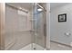 Contemporary glass enclosed shower with a tiled surround, built-in shelving, and modern fixtures at 2302 Fordcrest Dr, Apex, NC 27502