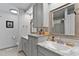 Bathroom with double sinks, granite countertops, and framed mirrors above matching gray vanities at 2302 Fordcrest Dr, Apex, NC 27502