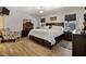 Comfortable bedroom features hardwood floors, a large bed, dresser, and chair with accent pillows at 2302 Fordcrest Dr, Apex, NC 27502