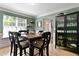 Stylish dining area featuring a dark wood table, matching chairs, and natural light from the window at 2302 Fordcrest Dr, Apex, NC 27502