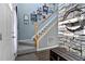 Open foyer featuring a staircase with stone accent wall, hardwood floors, and Gathering photos at 2302 Fordcrest Dr, Apex, NC 27502