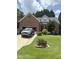Charming brick home with well-maintained lawn, attached garage, and beautiful landscaping at 2302 Fordcrest Dr, Apex, NC 27502