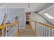 Bright hallway featuring wood floors, natural light, and a view into the main bedroom at 2302 Fordcrest Dr, Apex, NC 27502