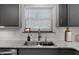 Bright kitchen showcasing a stainless steel sink, neutral countertops, and ample natural light through the window at 2302 Fordcrest Dr, Apex, NC 27502