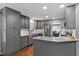 Updated kitchen boasts granite countertops, stainless steel appliances, and shaker cabinets at 2302 Fordcrest Dr, Apex, NC 27502