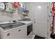 Well-organized laundry room includes a washer, dryer, storage shelves, and access to an exterior door at 2302 Fordcrest Dr, Apex, NC 27502